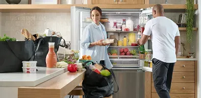 lg-counter-depth-french-door-refrigerator-couple-putting-groceries-away